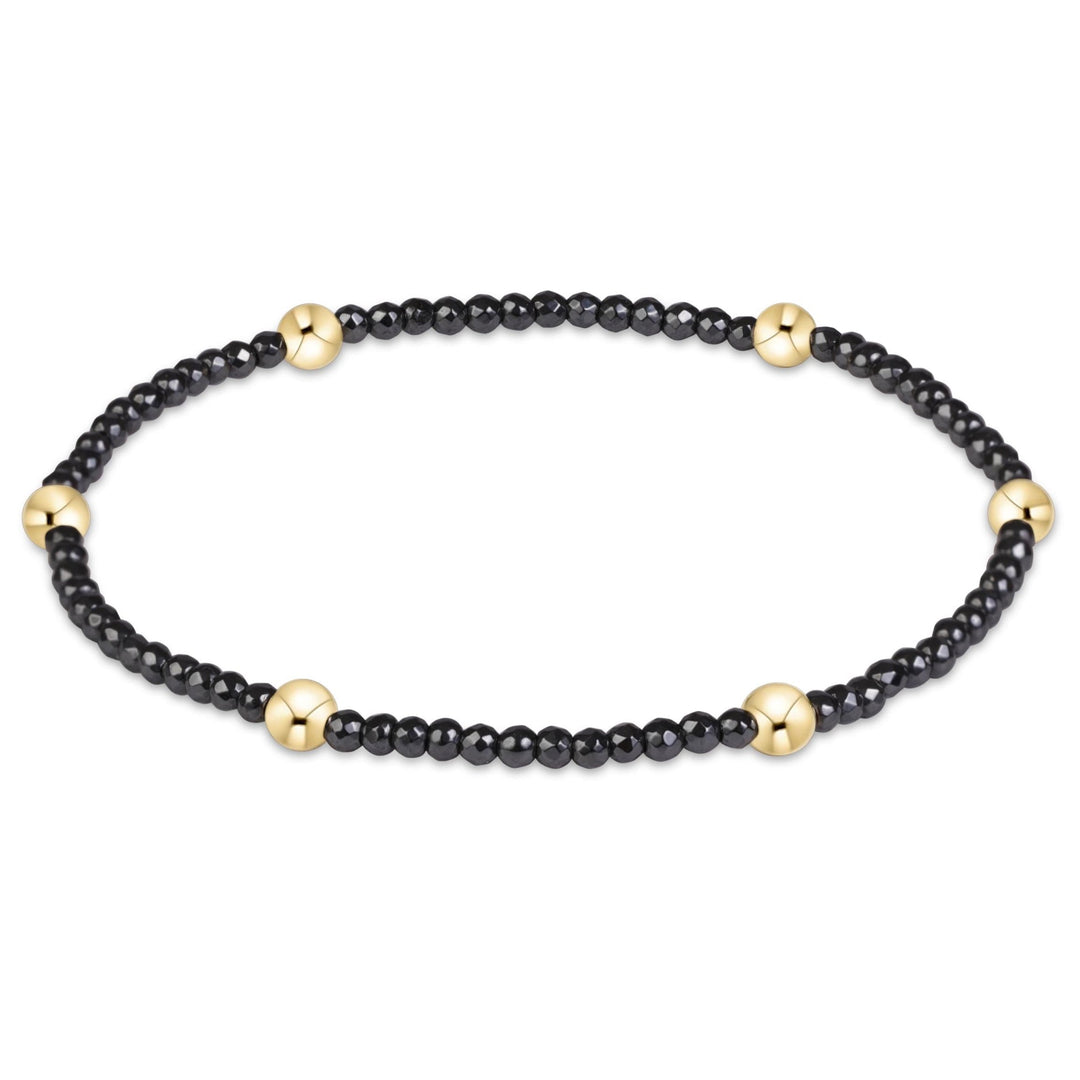 enewton Presence bracelet with 2mm faceted hematite beads in gunmetal grey, shown stacked on the wrist