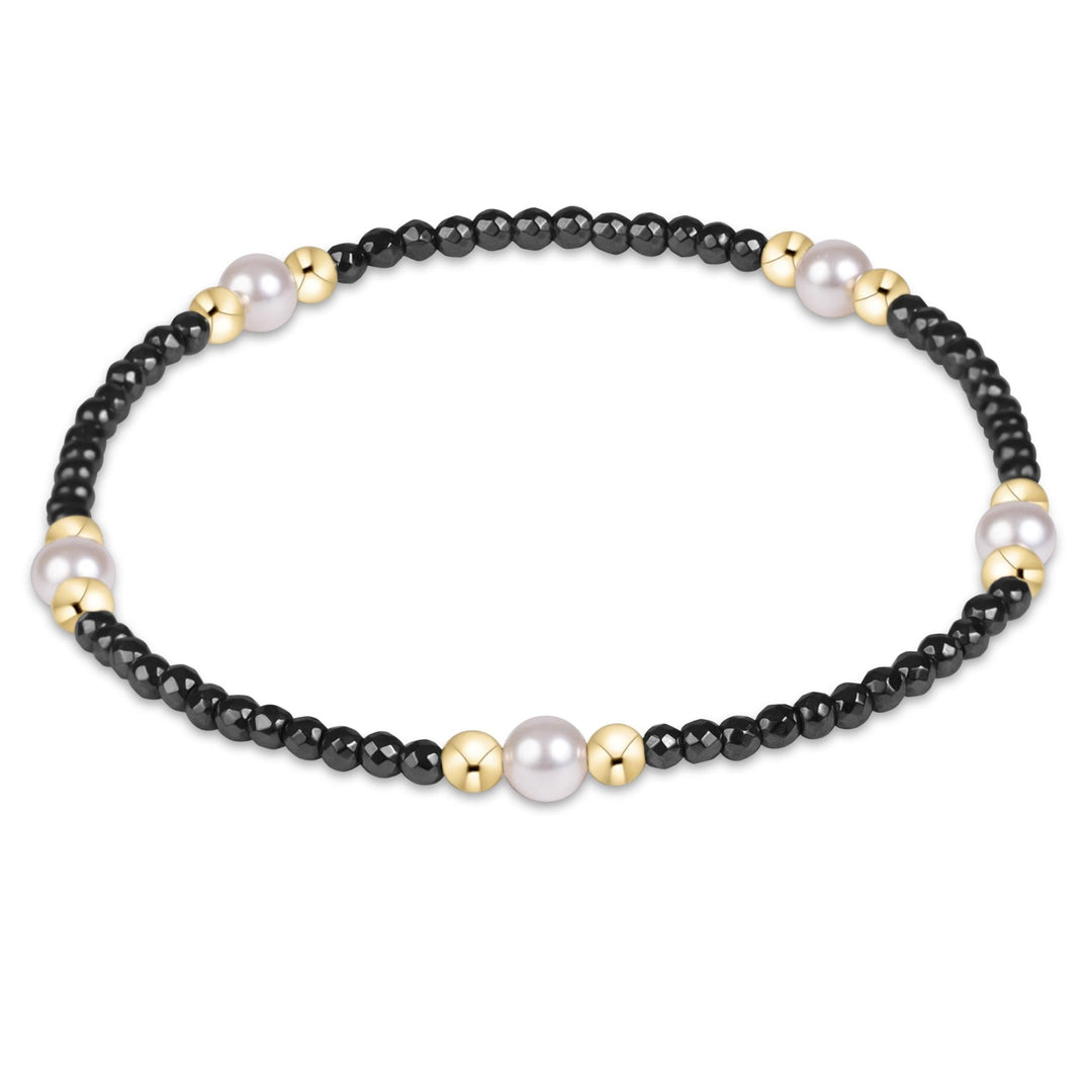enewton Purpose Pearl bracelet with 4mm pearls and faceted hematite beads, shown stacked on the wrist