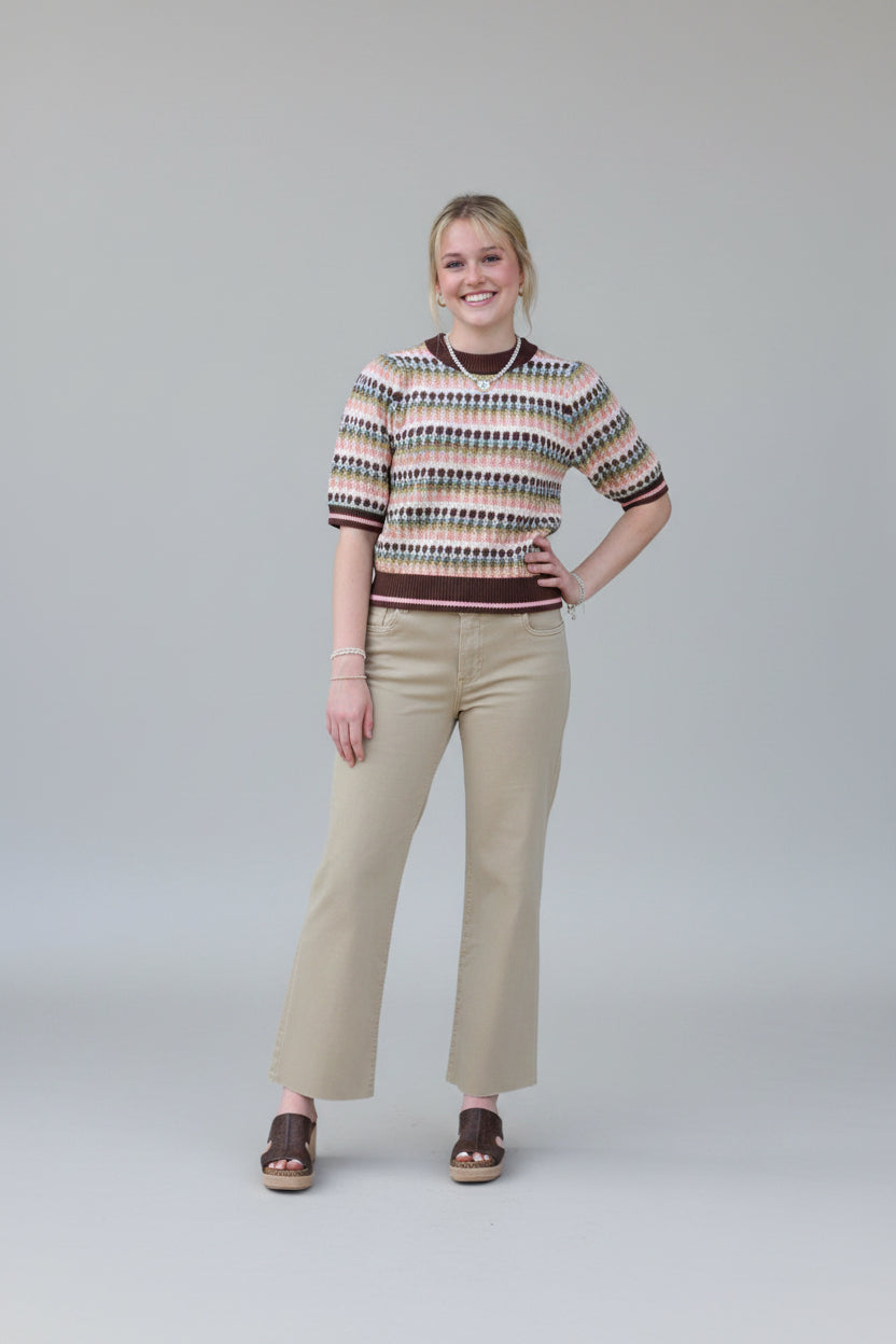 Model wearing the THML Mocha Geometric Knit Top featuring a warm brown pattern.