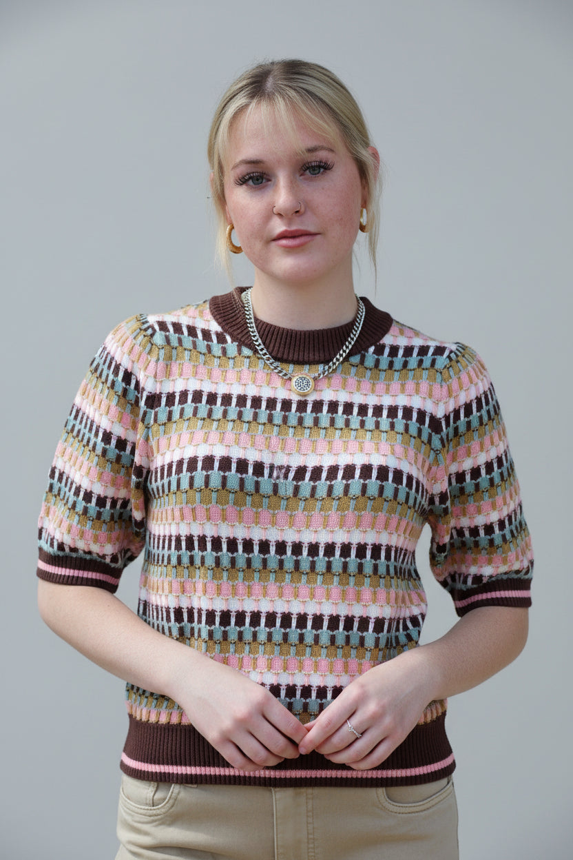 Model wearing the THML Mocha Geometric Knit Top featuring a warm brown pattern.
