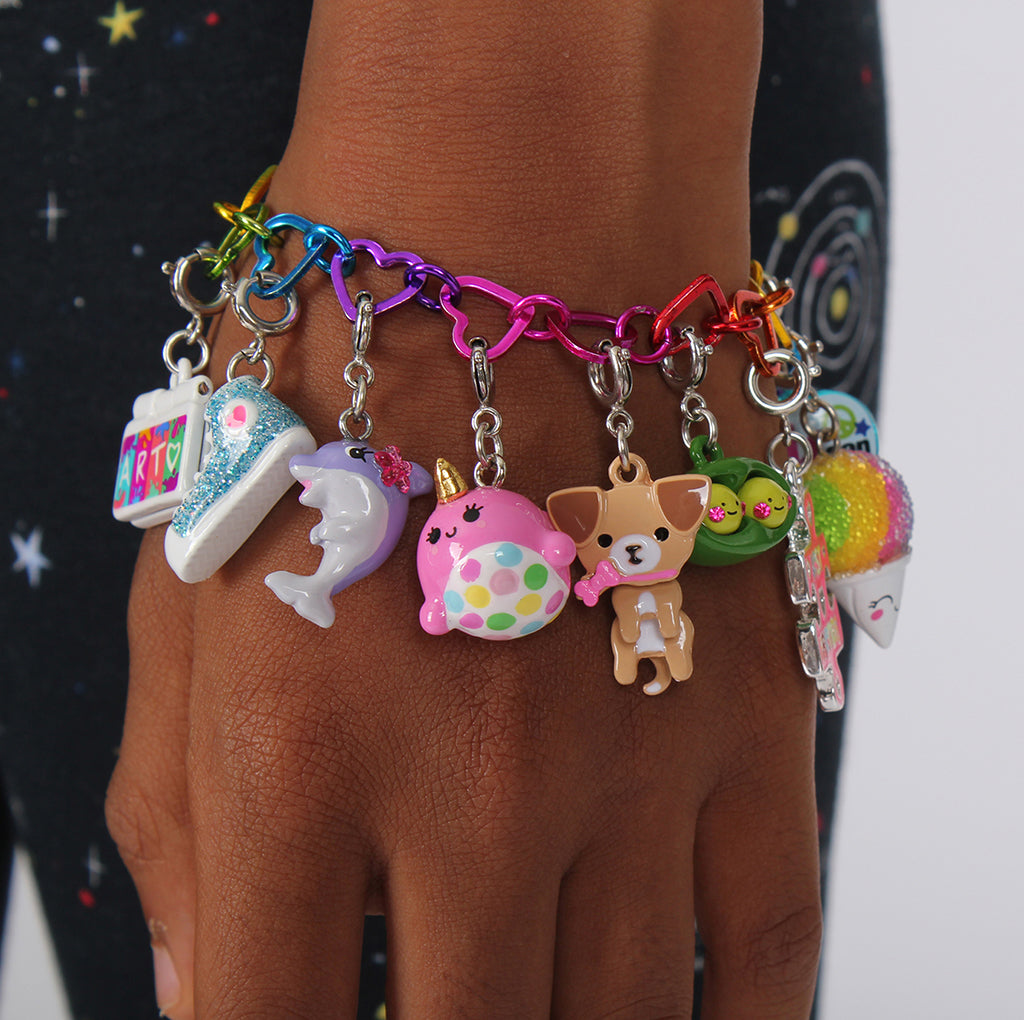 Charm It Pink Narwhal charm worn on a girls charm bracelet