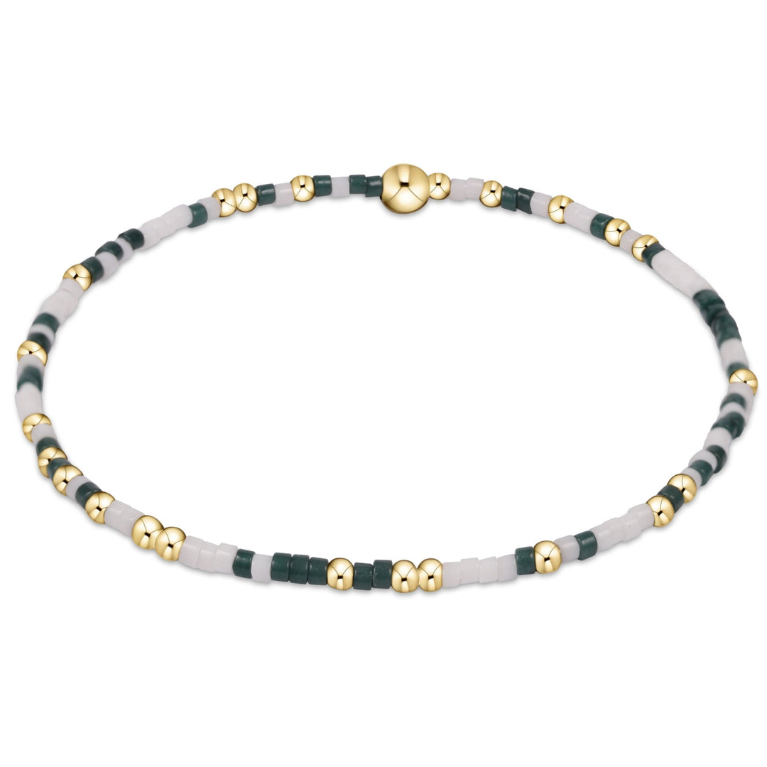 enewton eGirl Gameday Hope Unwritten bracelet in dark green and white beads, kid-sized, shown on the wrist