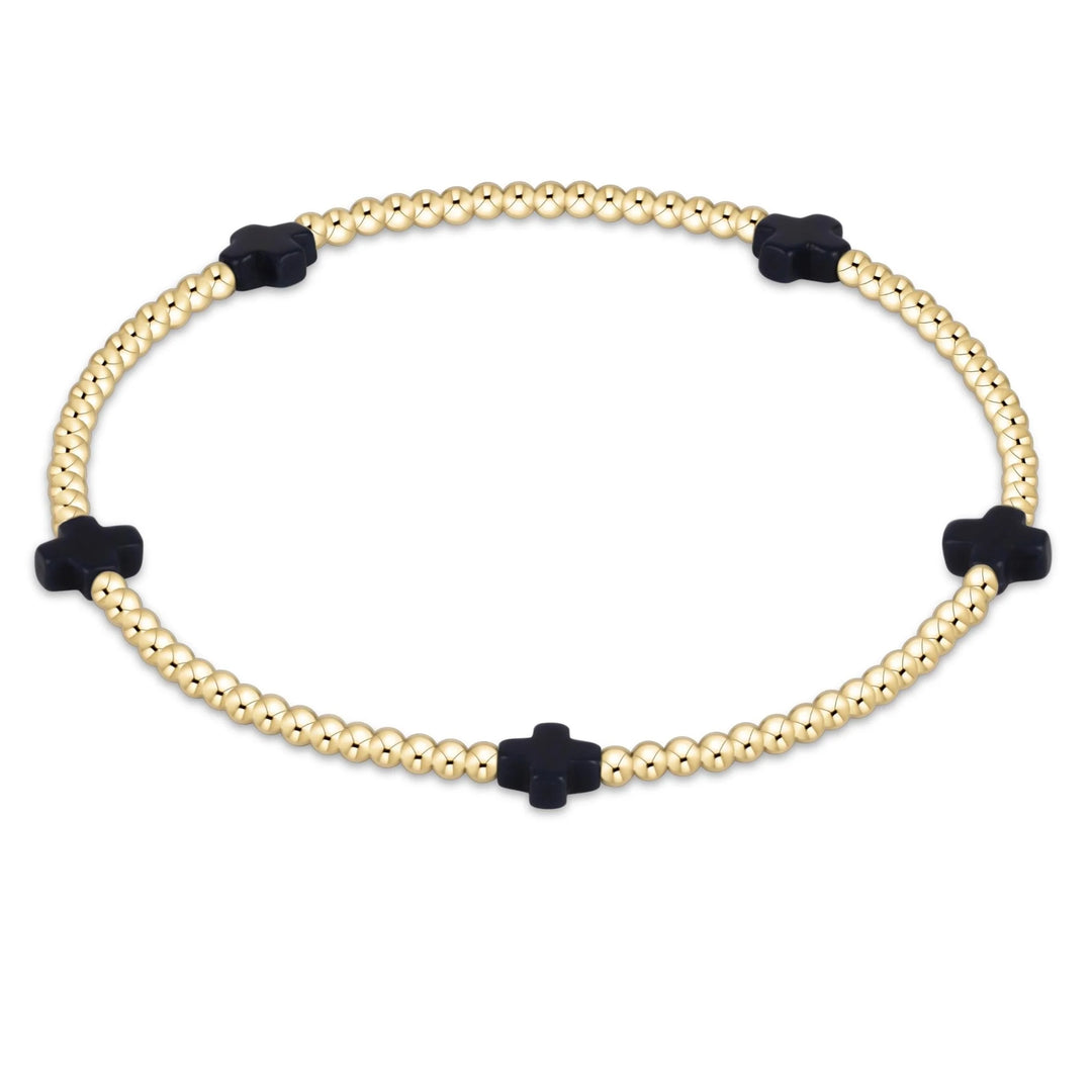 enewton Signature Cross Small 2mm Gold Bracelet in Navy highlighting its rich navy seed beads and 14k gold-filled cross pattern.