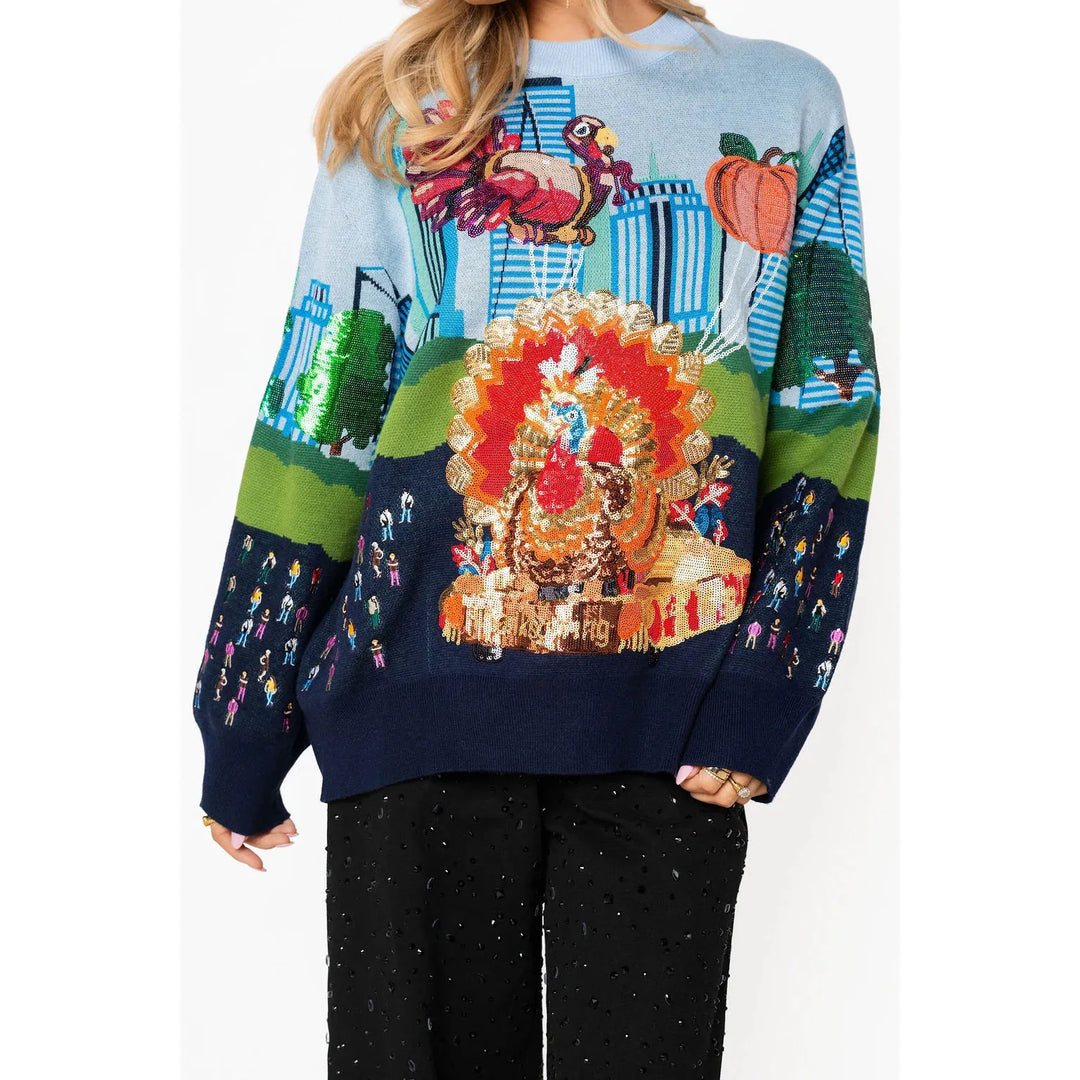 Model wearing the vibrant Queen of Sparkles Thanksgiving Parade sweater styled casually.