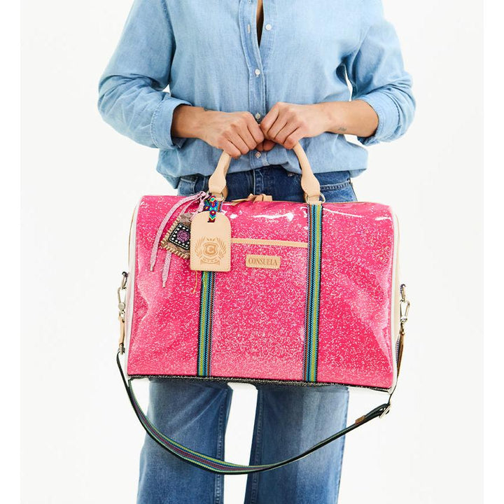 Consuela Bae Jetsetter duffel bag featuring a multicolored glitter exterior and natural leather handles.