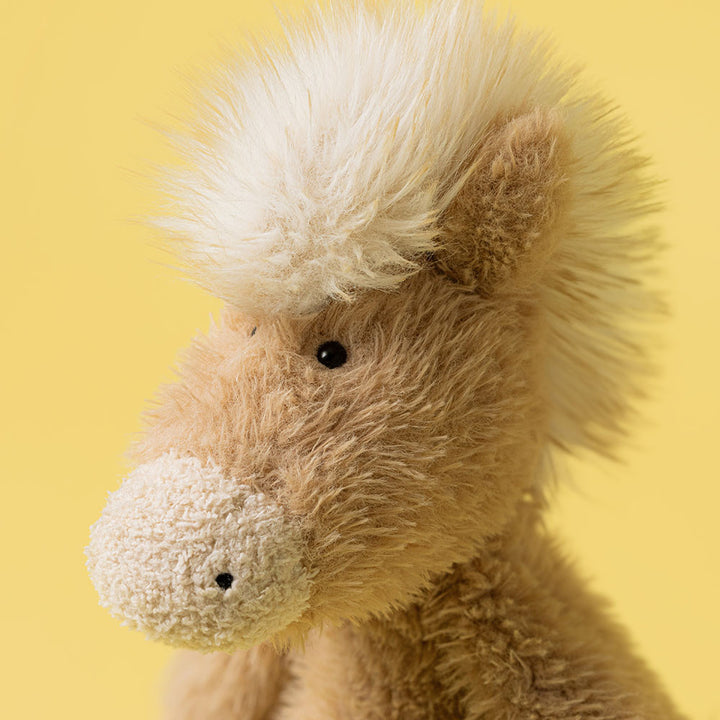 Profile shot of Canterneigh Pony showing his soft textured fur and upright sitting position.