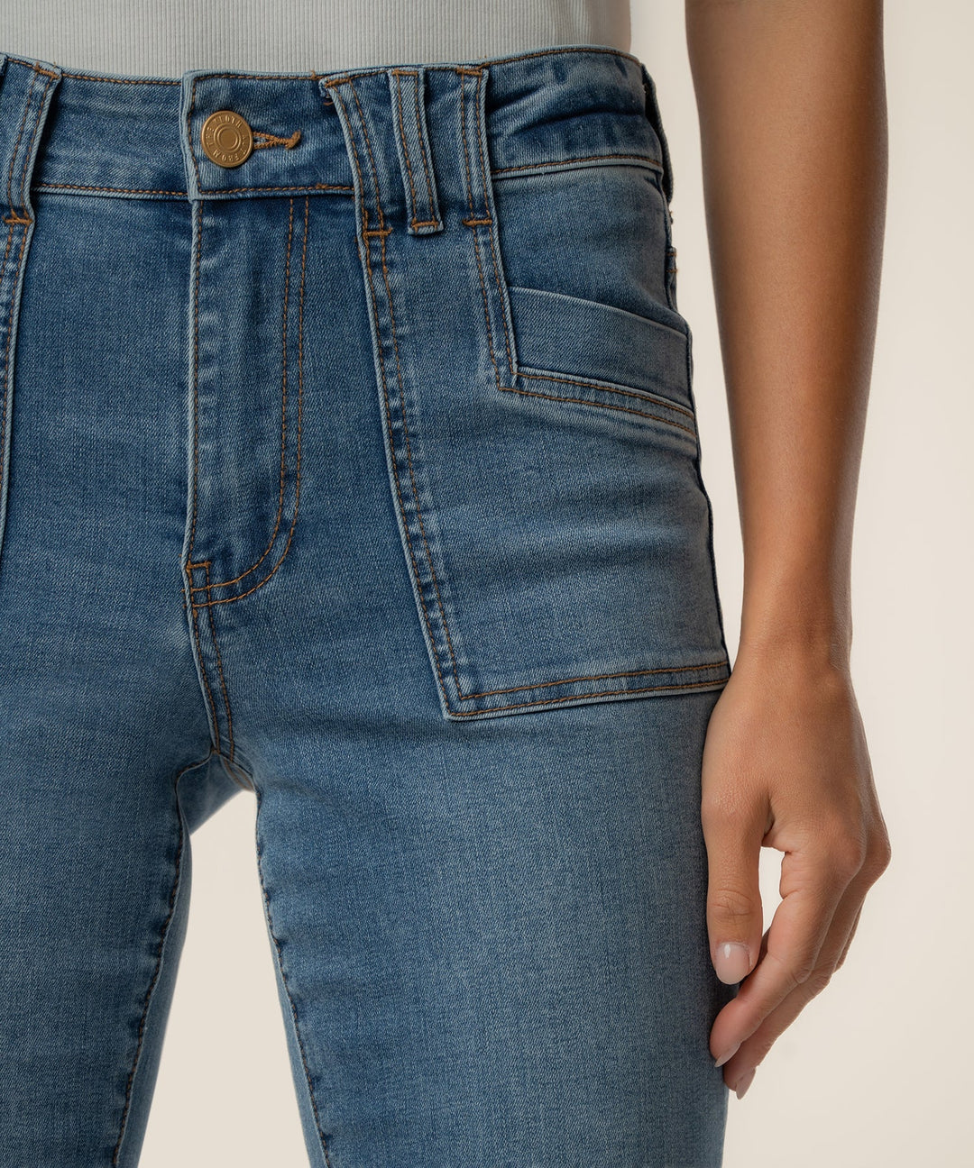 Kut from the Kloth Stella High Rise Flare Jeans in a medium wash featuring porkchop pockets and a clean hem.