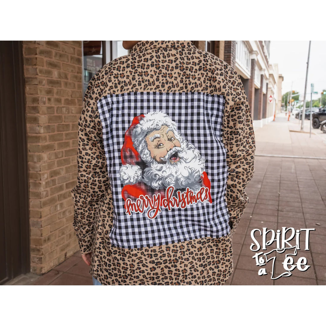 Model wearing the oversized Spirit to a Tee animal print Santa patch flannel styled over a casual outfit.