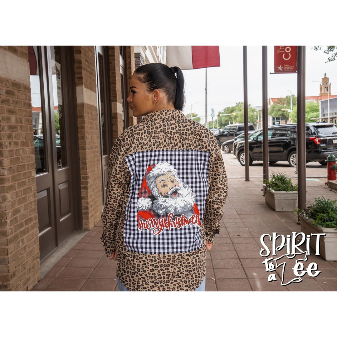 Model wearing the oversized Spirit to a Tee animal print Santa patch flannel styled over a casual outfit.