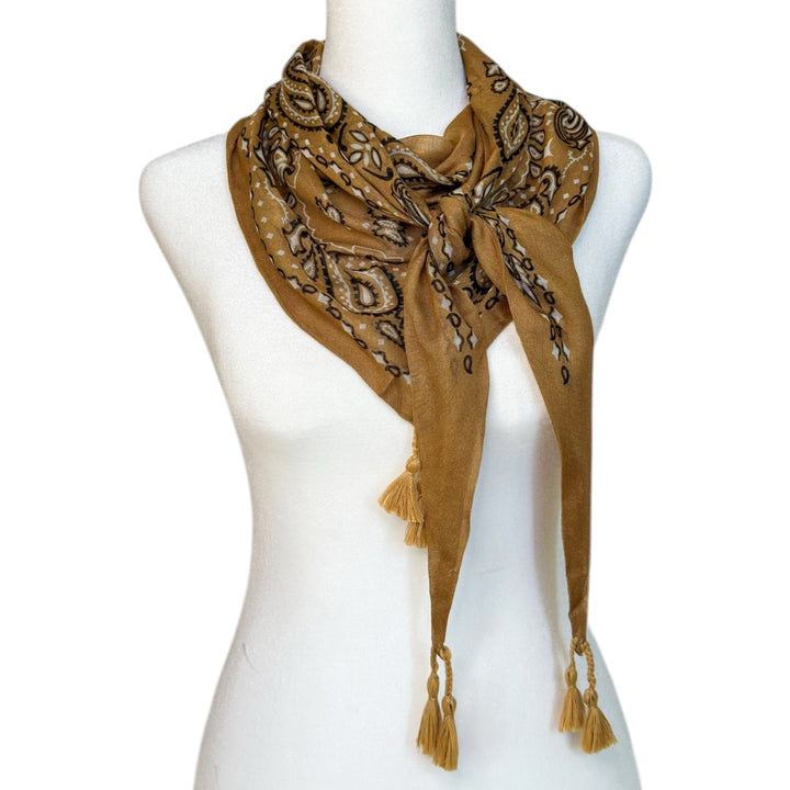 Winton and Waits rich brown tassel bandana styled as a scarf on a mannequin.