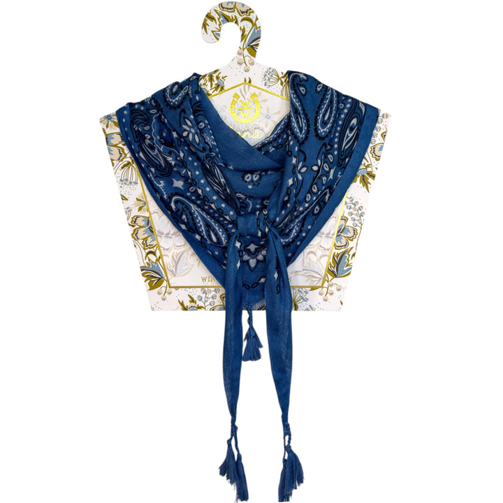 Winton and Waits denim blue tassel bandana folded on a display stand.