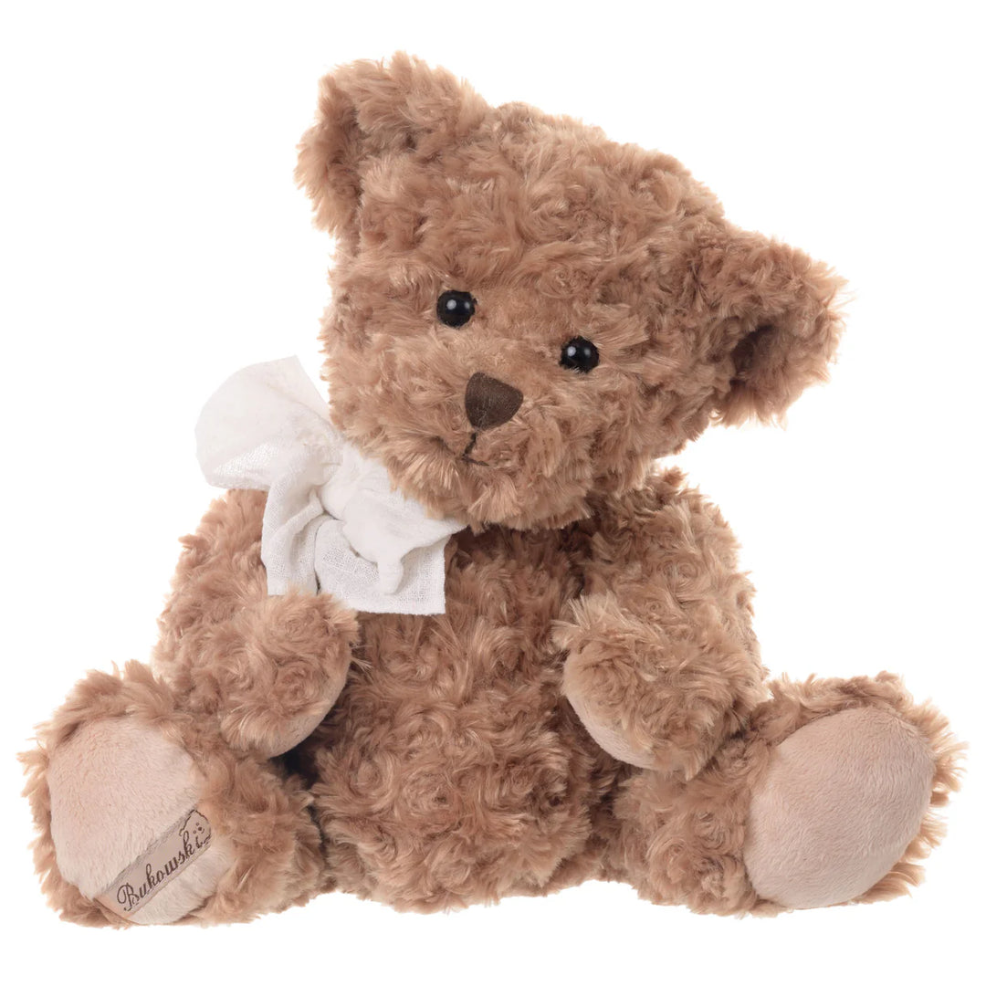 Brown plush bear named Ludwig with wavy fur and a white bow around its neck.