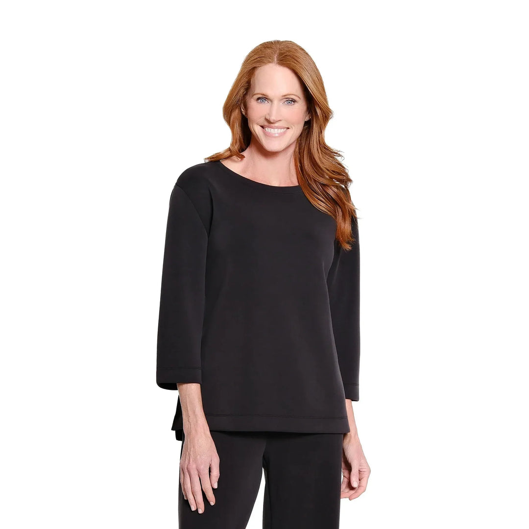 Multiples two-piece black knit set featuring a drop shoulder hi-low top and wide-leg ankle pants.