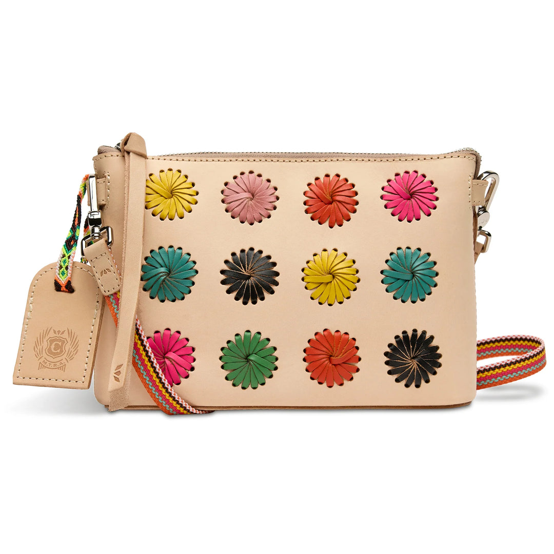 Consuela Paloma Midtown Crossbody featuring vibrant hand-laced multi-colored leather pinwheels on a Diego leather exterior.