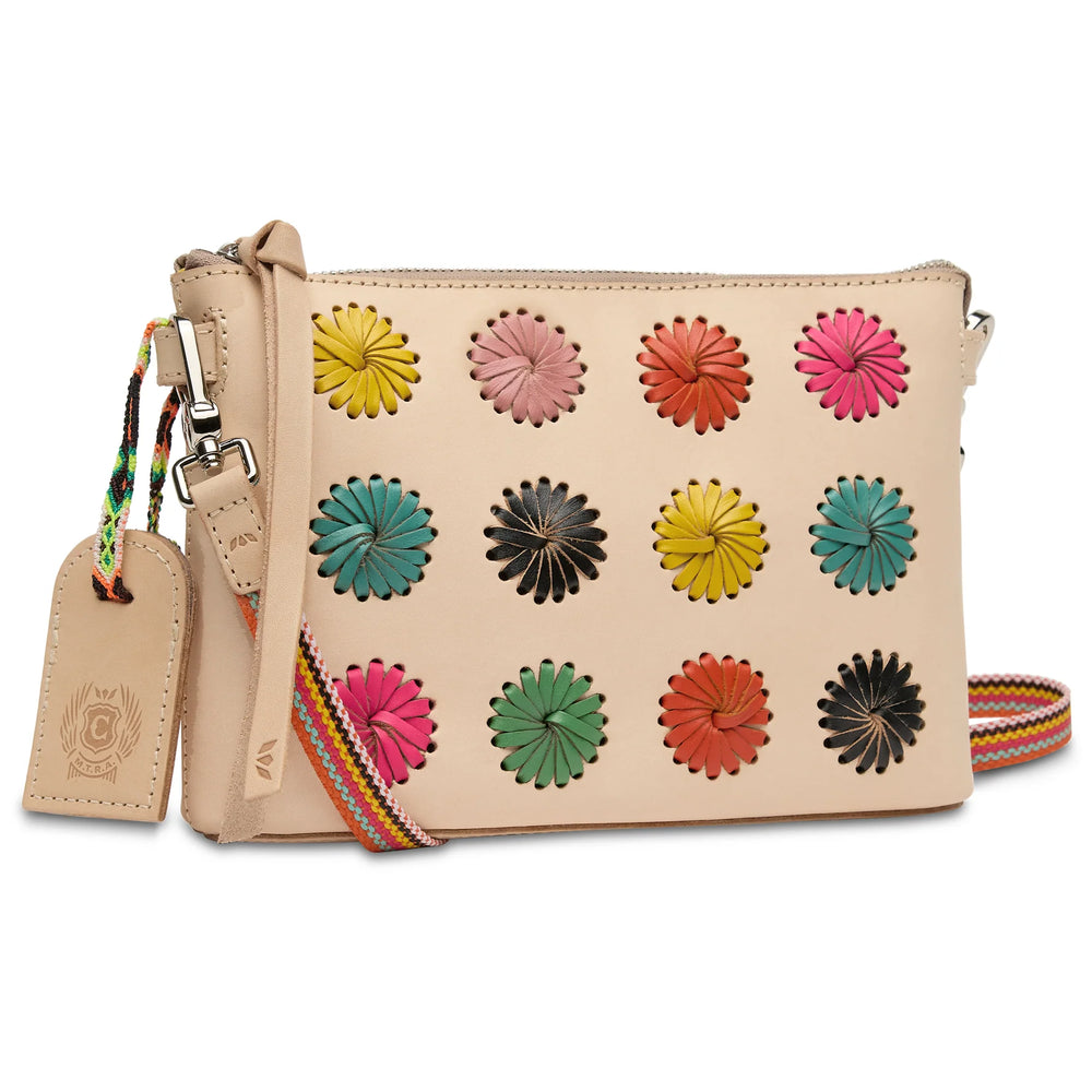 Close-up of the intricate hand-laced leather pinwheel detailing and natural leather trim on the Paloma bag.