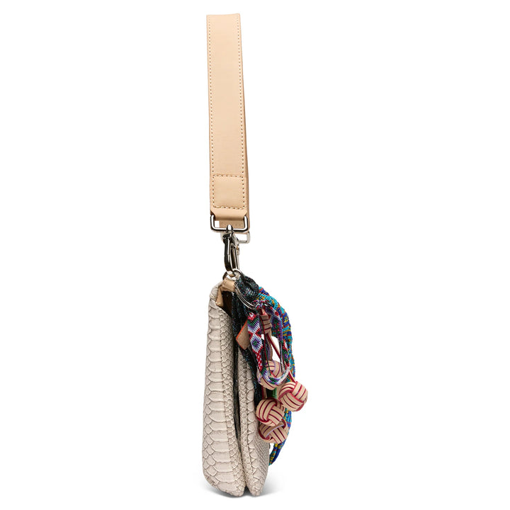 Side profile of the Thunderbird Metro Crossbody showing the smooth blue leather side panel and silver-tone hardware.