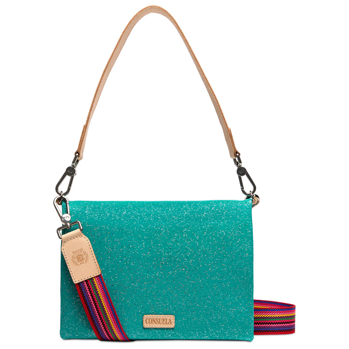 Consuela Shay Metro Crossbody, front view — sparkling teal with tan leather handle and rainbow woven crossbody strap