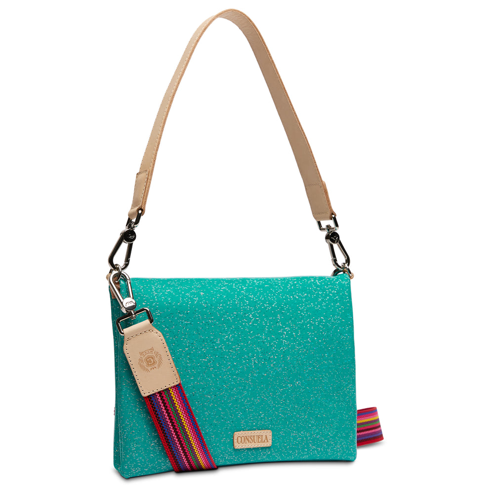 Consuela Shay Metro Crossbody front view showing rainbow-striped accent strap and Consuela leather tag, sparkling teal
