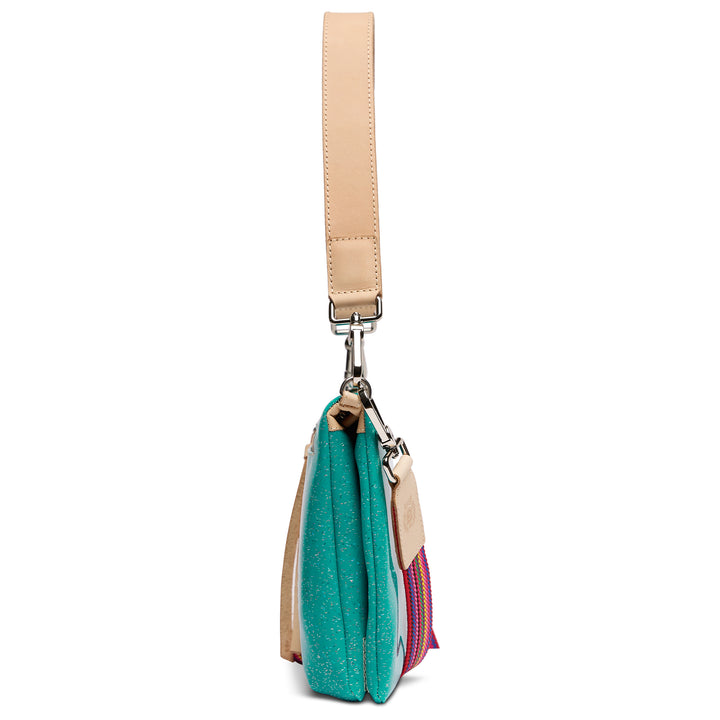 Consuela Shay Metro Crossbody side profile showing slim depth and tan leather handle, sparkling teal