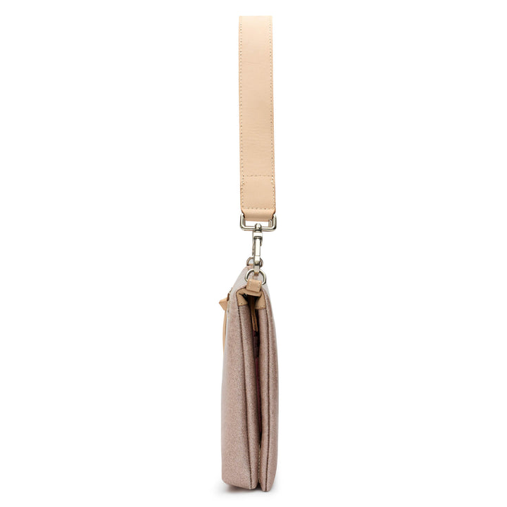 Side profile of the Consuela Emery Metro Crossbody showing its slim depth and natural leather strap.