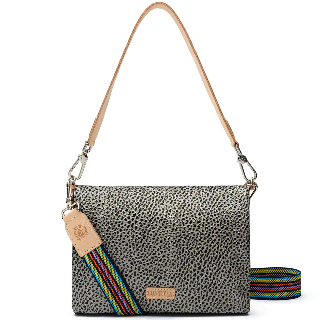Consuela Tommy Metro Crossbody front view, gray and black pebble print with rainbow-striped woven crossbody strap