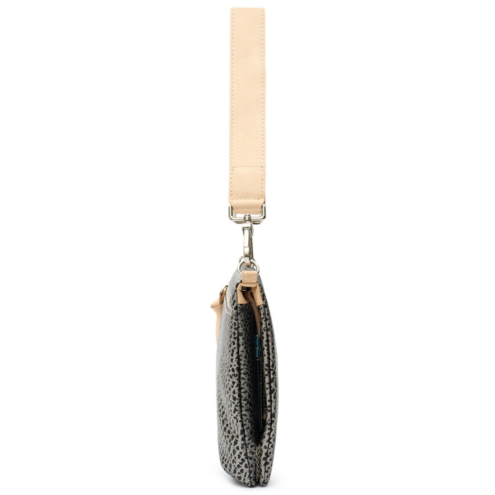 Consuela Tommy Metro Crossbody side profile with tan leather handle, zipper pull, and metal hardware