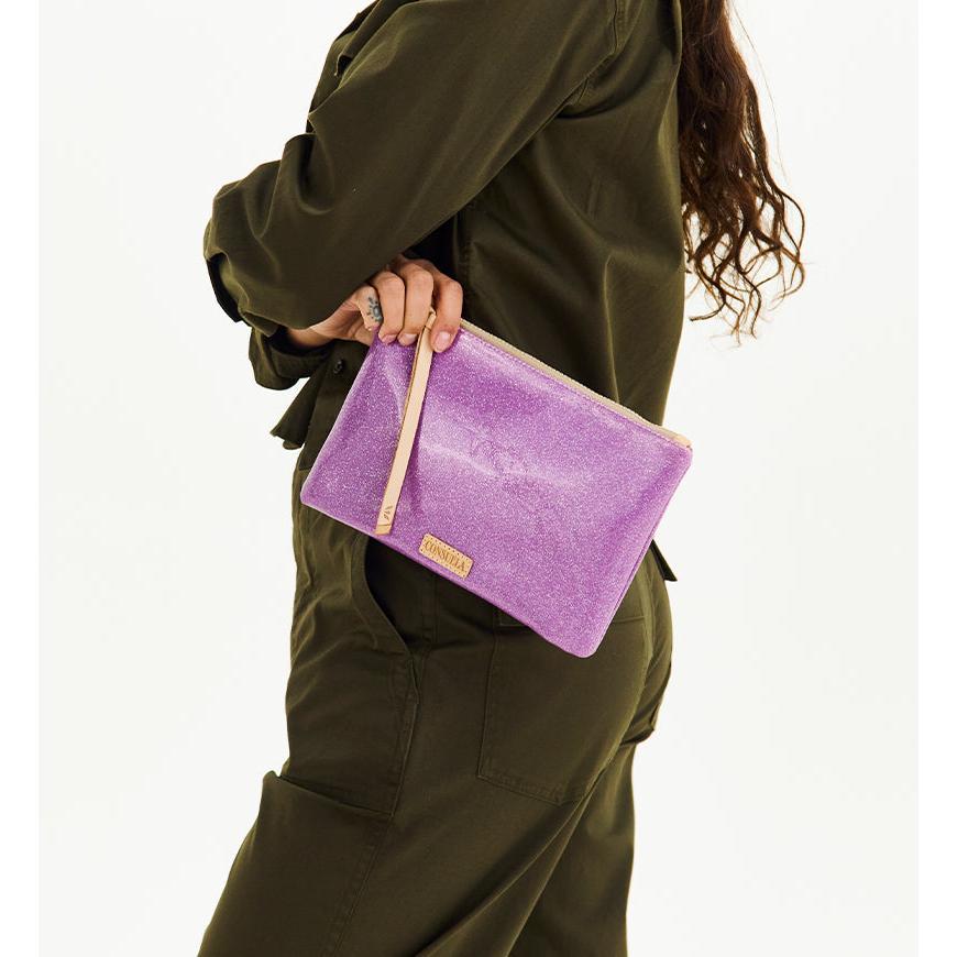 Consuela Twy Mighty Pouch featuring a bright purple glitter exterior and natural leather zipper pull.