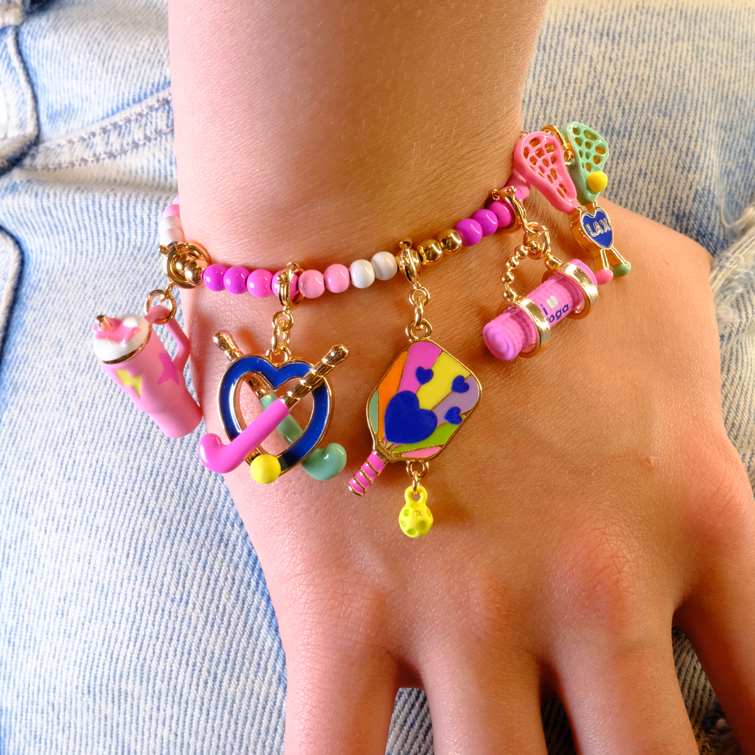 Charm It Gold On-the-Go Cup charm on a sports-themed kids charm bracelet