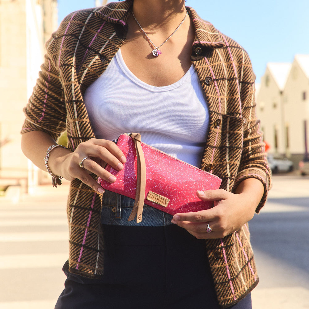 Consuela Bae Pop Pouch featuring a multicolored glitter exterior and natural leather zipper pull.
