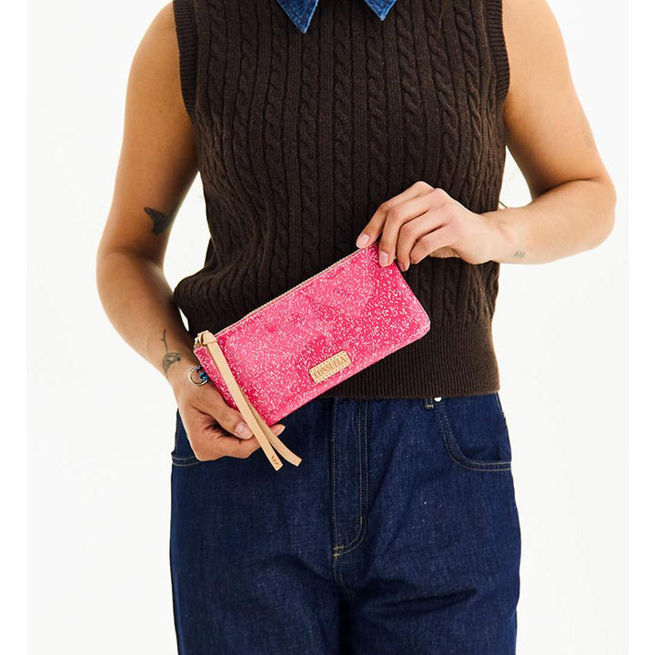 Consuela Bae Pop Pouch featuring a multicolored glitter exterior and natural leather zipper pull.