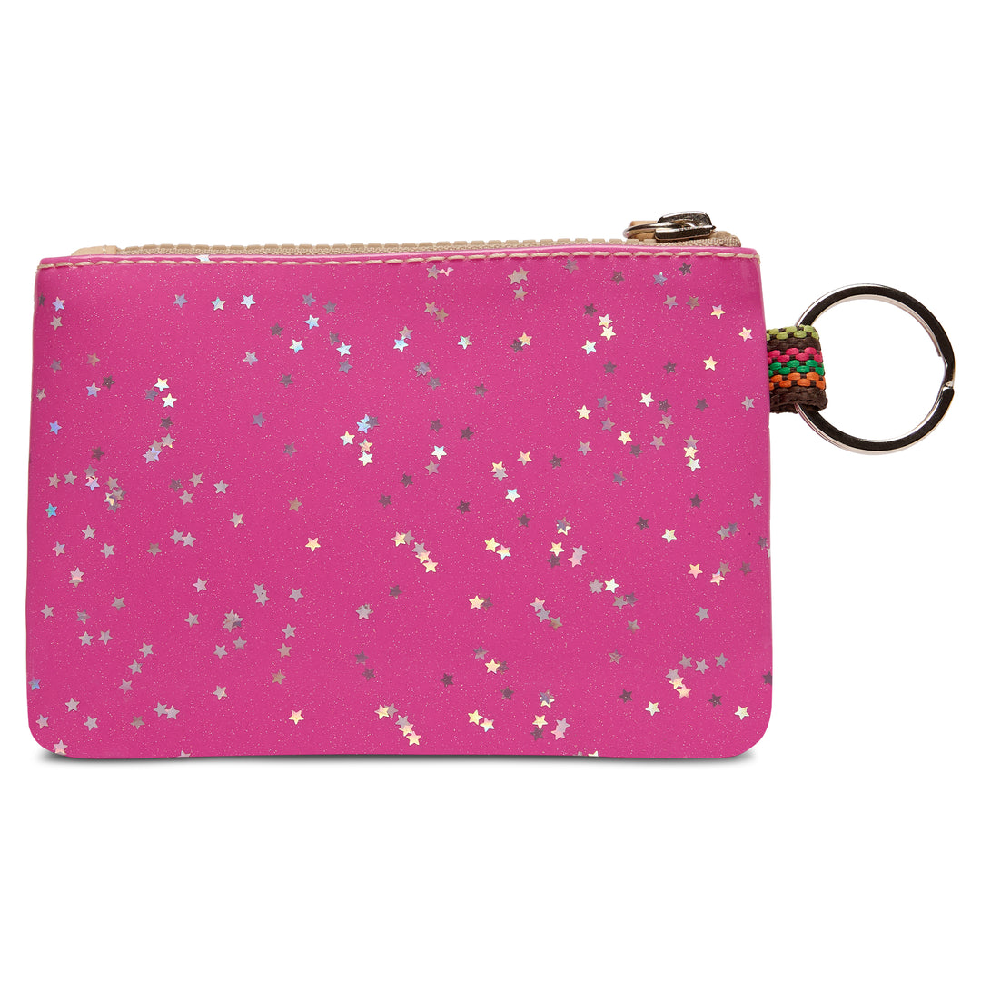 Showing the back of the Consuela Berry  pouch, decorated with scattered silver, gold, and white star confetti, featuring a gold zipper and a metal key ring attached on the  side.