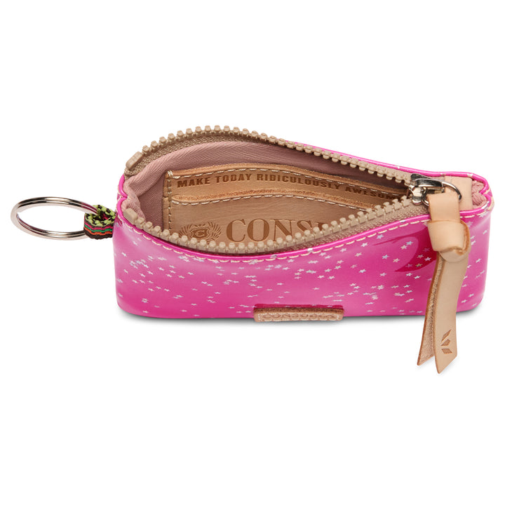 The inside of the Consuela Berry pouch with a white speckled pattern, shown open to reveal a light pink leather interior and a key ring attachment on the left.