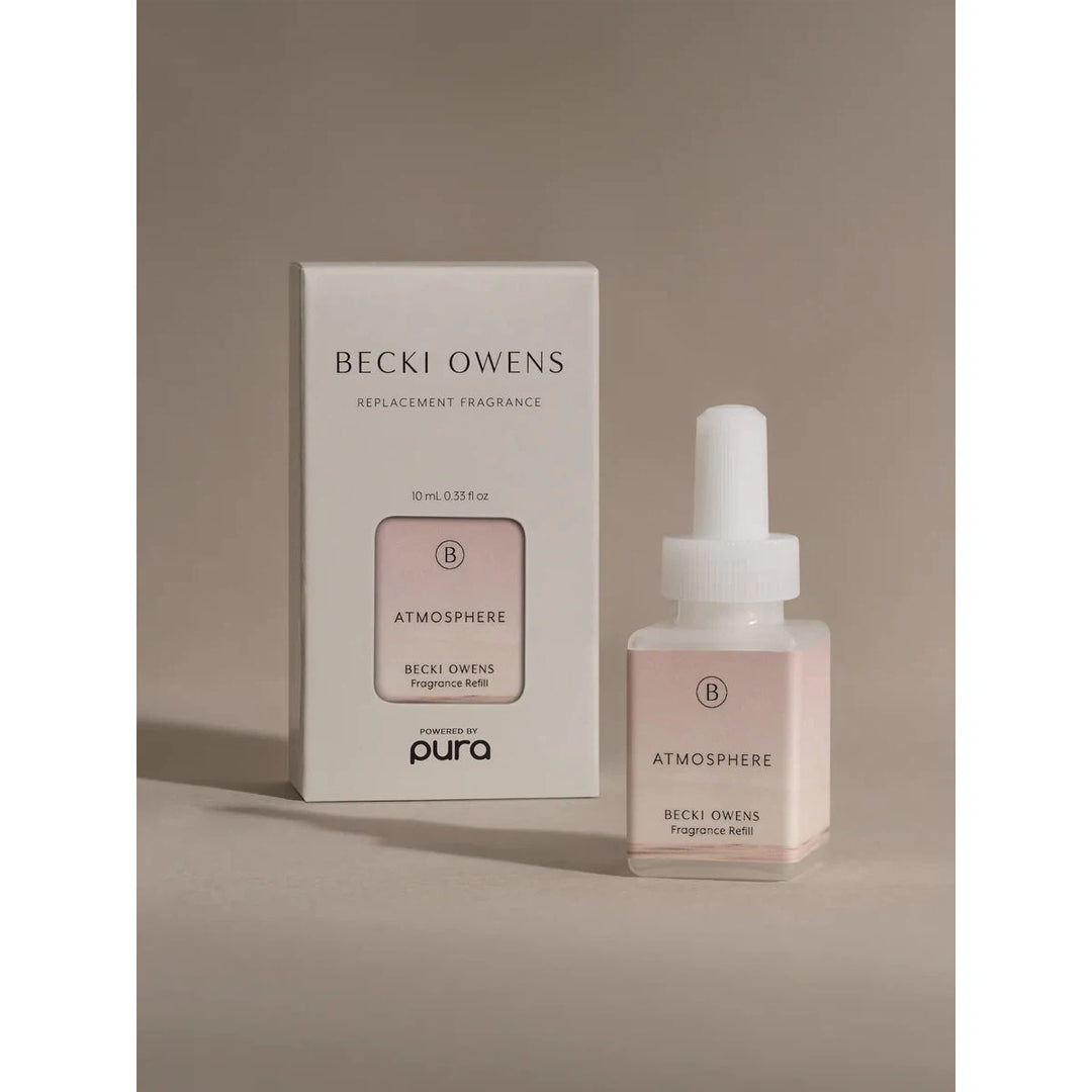 Pura smart fragrance vial in Atmosphere by Becki Owens, featuring a minimalist white label with delicate floral sketches.