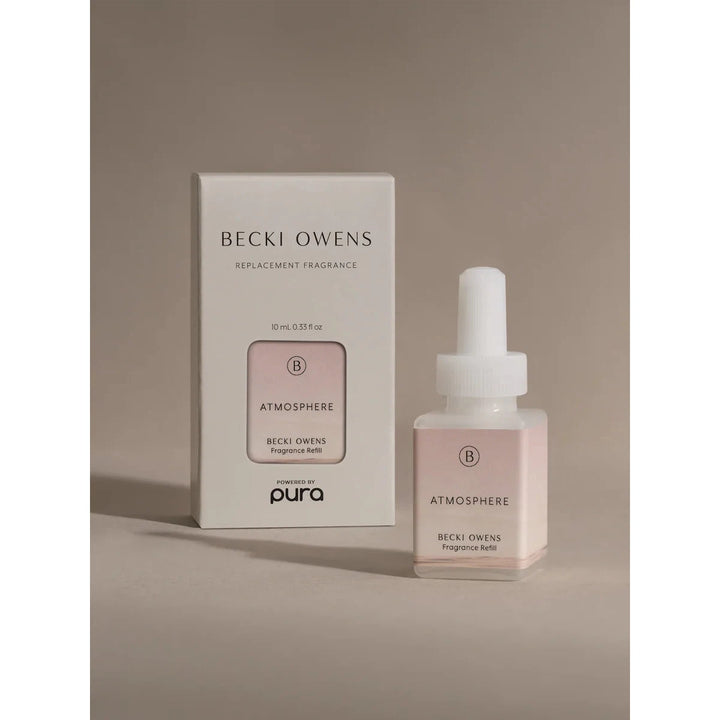 Pura smart fragrance vial in Atmosphere by Becki Owens, featuring a minimalist white label with delicate floral sketches.
