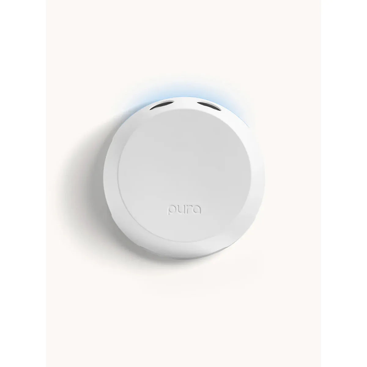 White Pura 4 smart home fragrance diffuser shown plugged into a wall outlet, modern design.