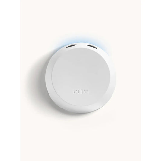 White Pura 4 smart home fragrance diffuser shown plugged into a wall outlet, modern design.