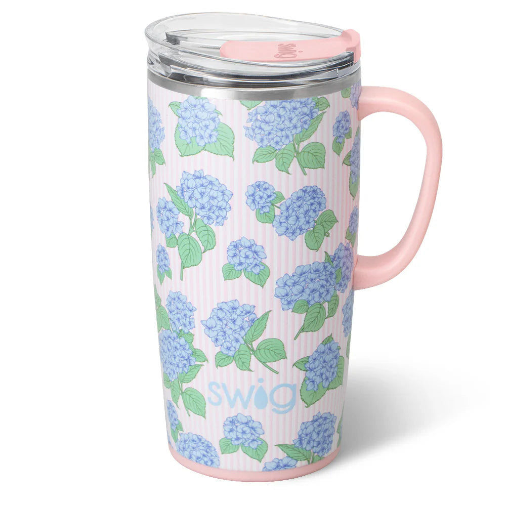 22oz insulated travel mug by Swig Life with a blue and pink hydrangea pattern and a pink handle.