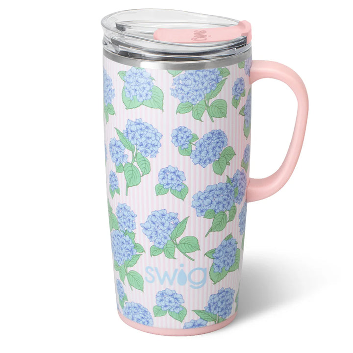 22oz insulated travel mug by Swig Life with a blue and pink hydrangea pattern and a pink handle.