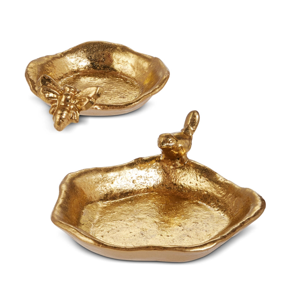 Two gold ceramic dishes with animal figurines on a white background