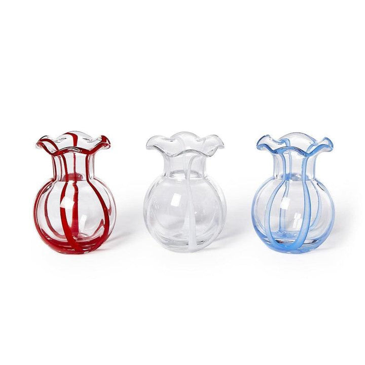 Three glass vases in red, clear, and blue on a white background