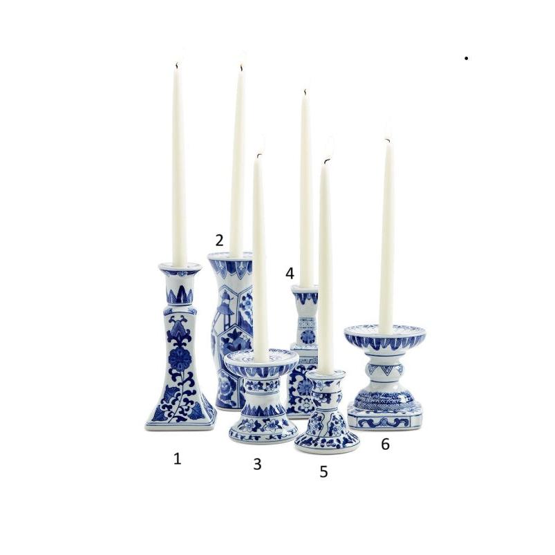 Set of six blue and white candle holders with candles on a white background