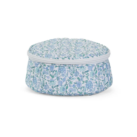 Round quilted jewelry travel case in blue and white Hamptons Floral print with white zipper and interior organizers.