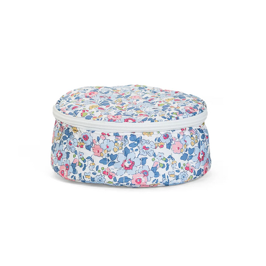 Round quilted jewelry travel case in a blue and white Bridgehampton Floral print with a white zipper and top handle.