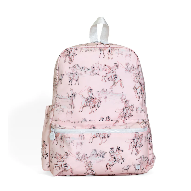 Pink and white Cowgirl Toile print backpack with white zippers, padded straps, and side pockets.