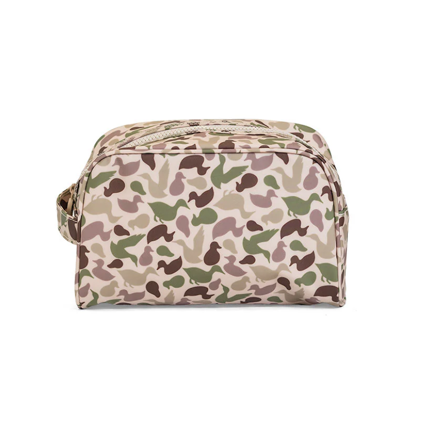 TRVL Design Stowaway Toiletry Bag in green Decoy camo; large wipeable and water-resistant cosmetic bag with side handle.