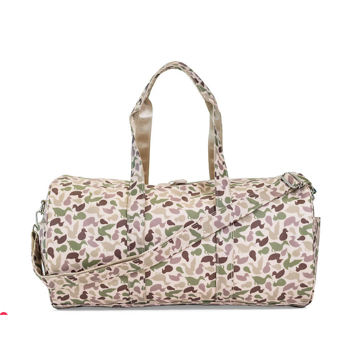 TRVL Design Large Roll Duffel in green Decoy camo; water-resistant travel bag with white chunky zipper and shoulder strap.