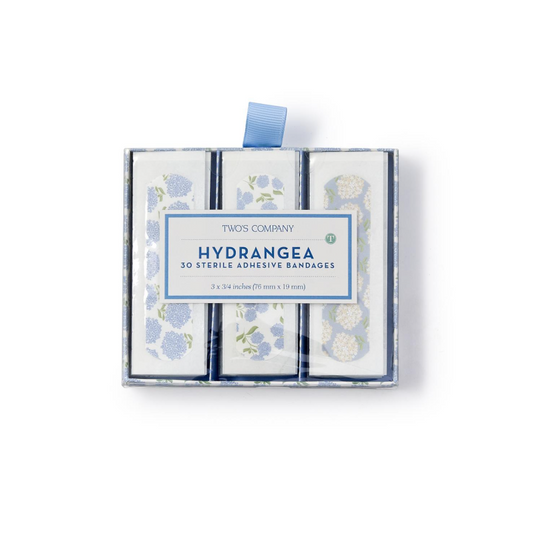 Two's Company Hydrangea bandages in a decorative gift box; featuring blue, pink, and purple floral patterns.