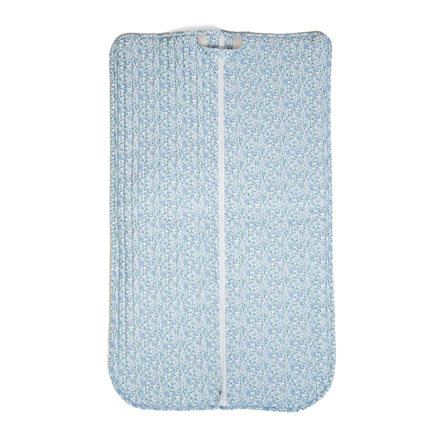 TRVL Design quilted travel garment bag in a soft blue and white Hampton Floral pattern with top carrying loops.