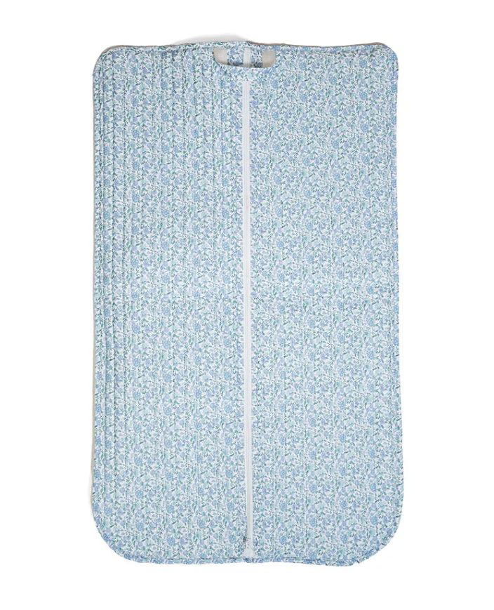 TRVL Design quilted travel garment bag in a soft blue and white Hampton Floral pattern with top carrying loops.