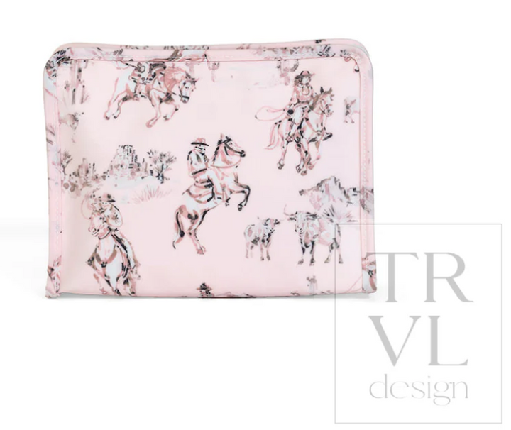 TRVL Design Roadie Medium Zip Pouch in Cowgirl Toile print highlighting its flat, single-compartment zippered makeup bag silhouette.